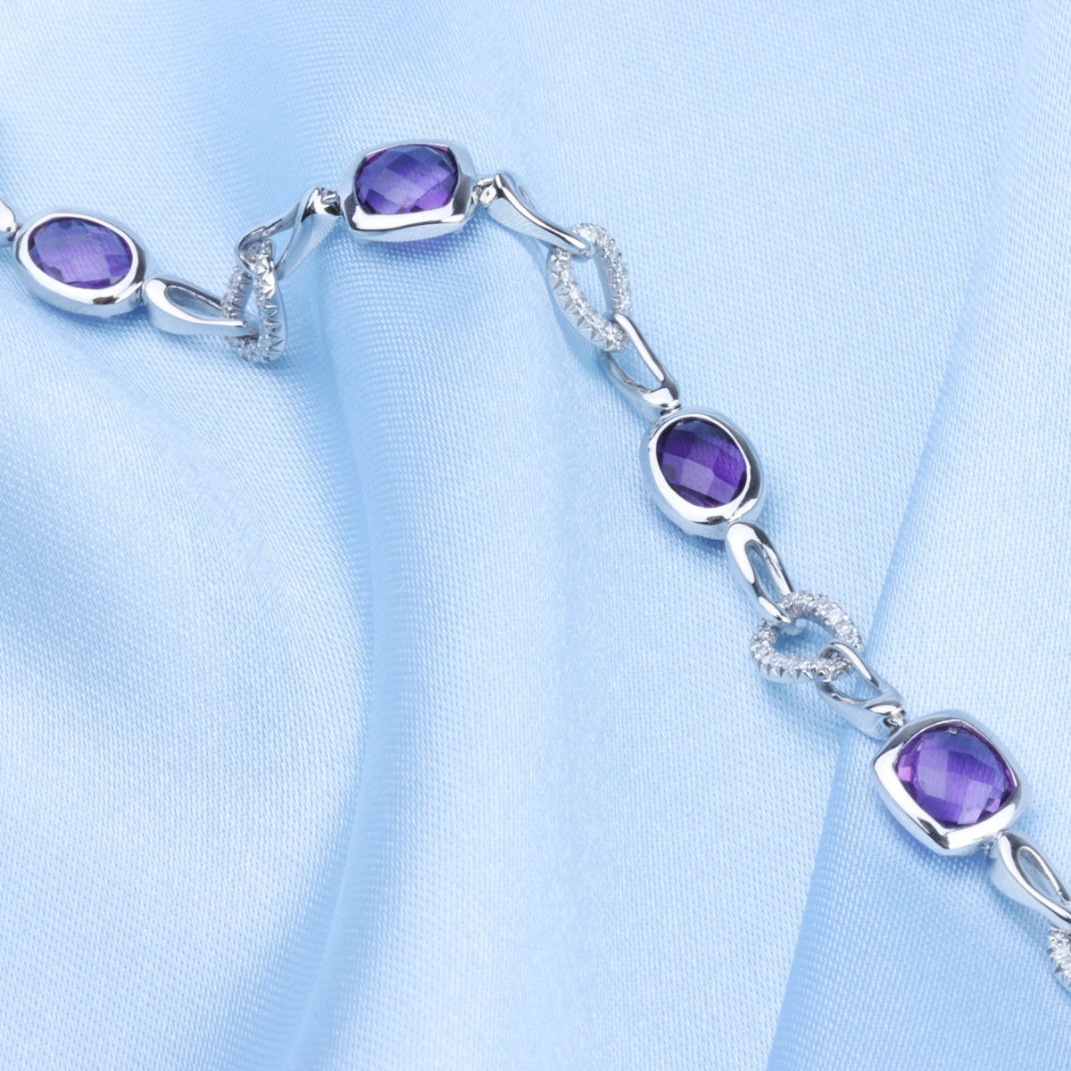 Modern shape in alternating pave diamond links with a variety of gemstones  for self-expression. 