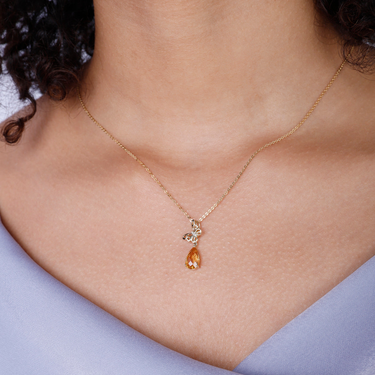 Timeless butterfly design in gold with a dangling gemstone. Variety of gemstone for self-expression